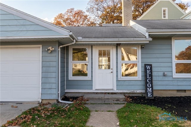 view of exterior entry featuring a garage