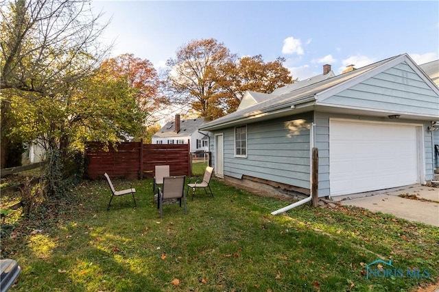 exterior space featuring a garage and a yard