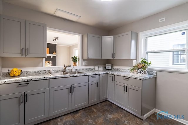 kitchen with gray cabinetry and sink