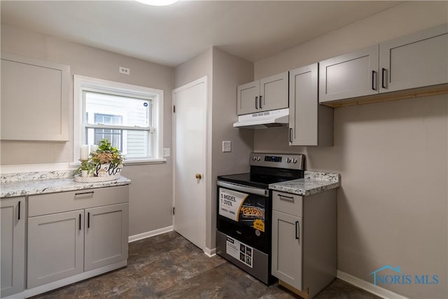 kitchen with light stone countertops and electric stove