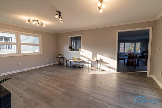 unfurnished room featuring hardwood / wood-style flooring and ornamental molding