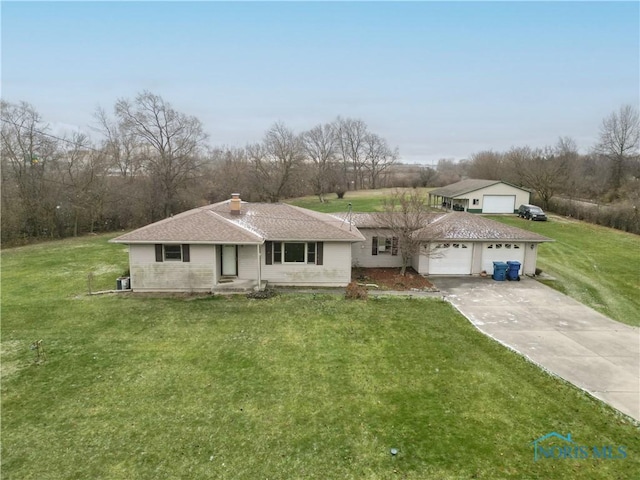 ranch-style home featuring a garage and a front yard