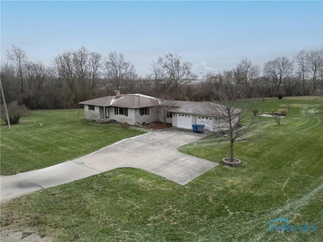 view of front of home featuring a garage and a front lawn