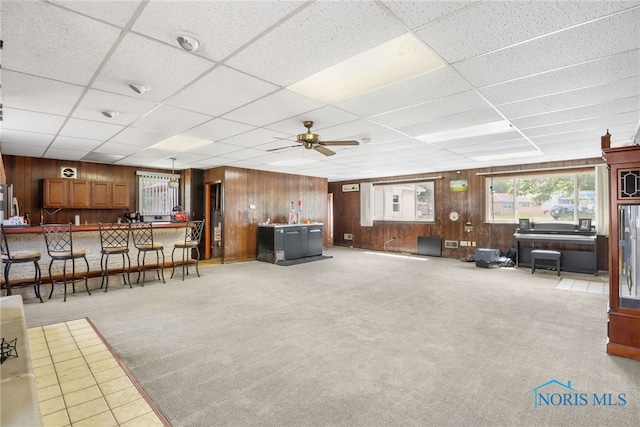 carpeted living room with a paneled ceiling and ceiling fan