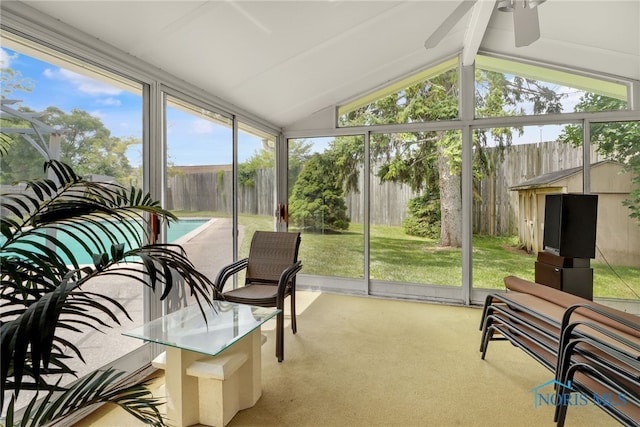 sunroom with ceiling fan, a healthy amount of sunlight, and vaulted ceiling