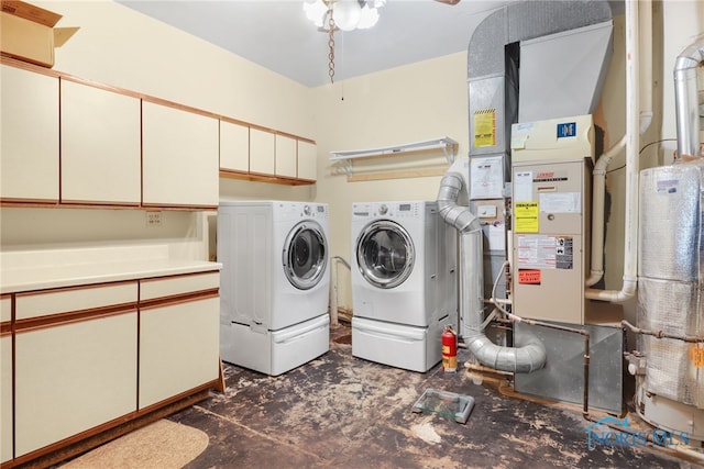 laundry area with washer and clothes dryer and cabinets