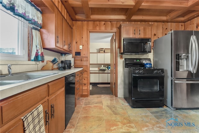 kitchen with wood walls, coffered ceiling, black appliances, sink, and wood ceiling