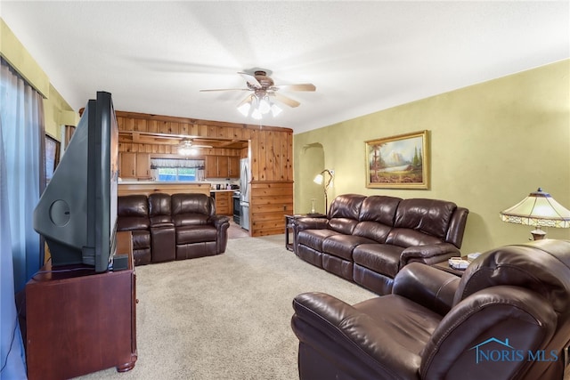 living room with light carpet and ceiling fan