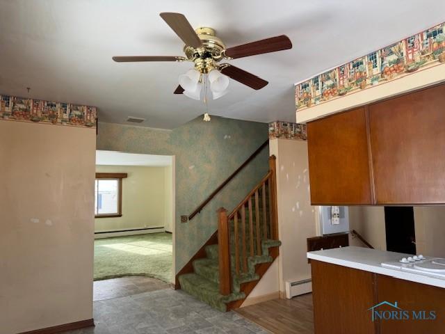 kitchen with kitchen peninsula, baseboard heating, and ceiling fan