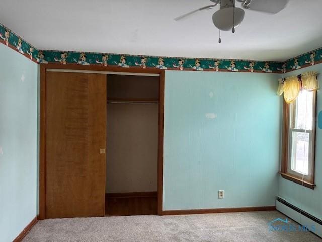 unfurnished bedroom with ceiling fan, a closet, carpet floors, and a baseboard radiator