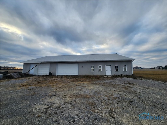 exterior space with a garage and an outdoor structure