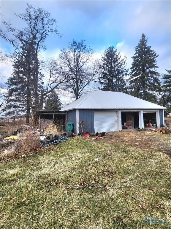 exterior space with an outbuilding and a garage