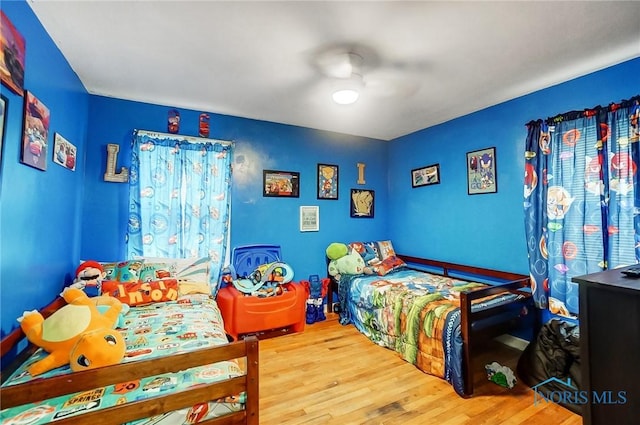 bedroom featuring hardwood / wood-style flooring and ceiling fan