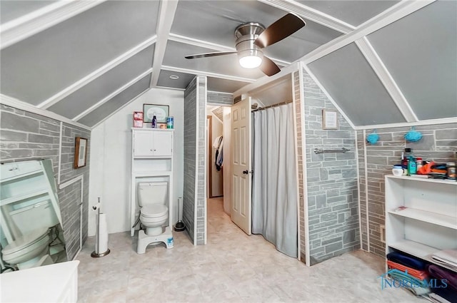 bathroom featuring ceiling fan, toilet, and vaulted ceiling