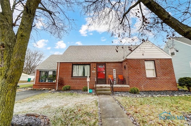 bungalow-style home with a front yard