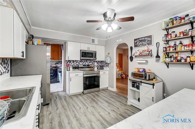 kitchen featuring white cabinets, appliances with stainless steel finishes, and light stone countertops