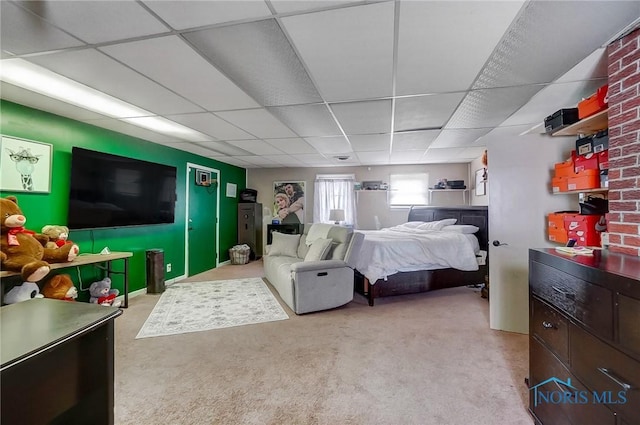 carpeted bedroom with a paneled ceiling