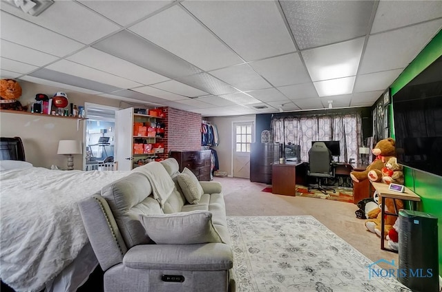 carpeted bedroom with a drop ceiling