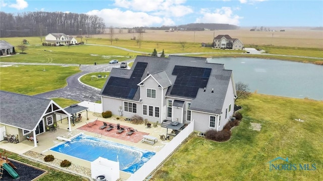 back of property featuring solar panels and a patio