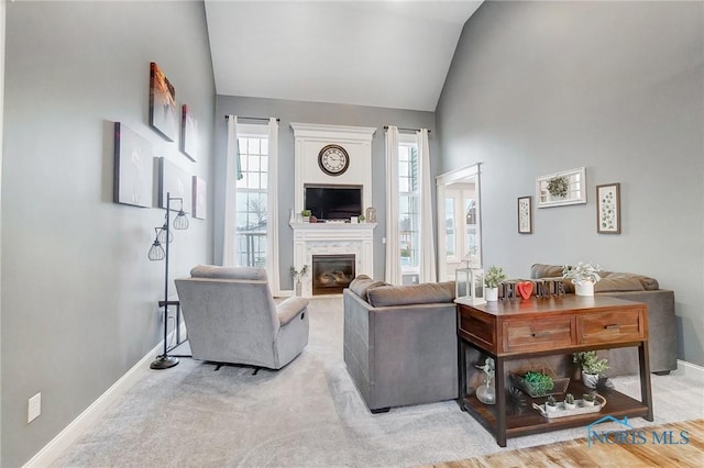 living room featuring lofted ceiling and light carpet