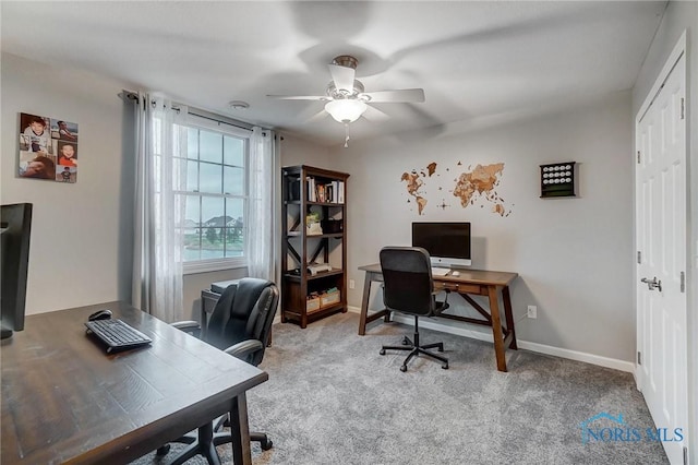 carpeted office space with ceiling fan