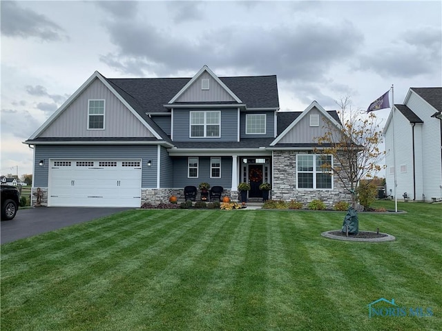 craftsman-style house with a front lawn and a garage