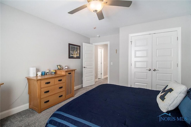 bedroom featuring light colored carpet, a closet, and ceiling fan