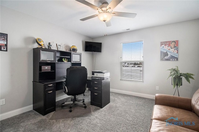 office space with ceiling fan and dark colored carpet