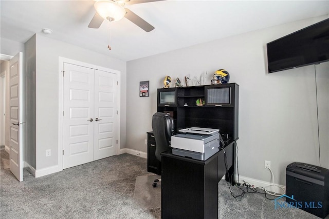 carpeted home office featuring ceiling fan