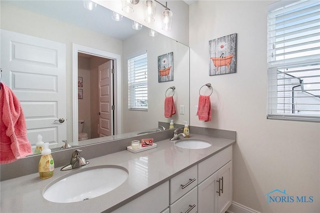 bathroom featuring vanity and toilet