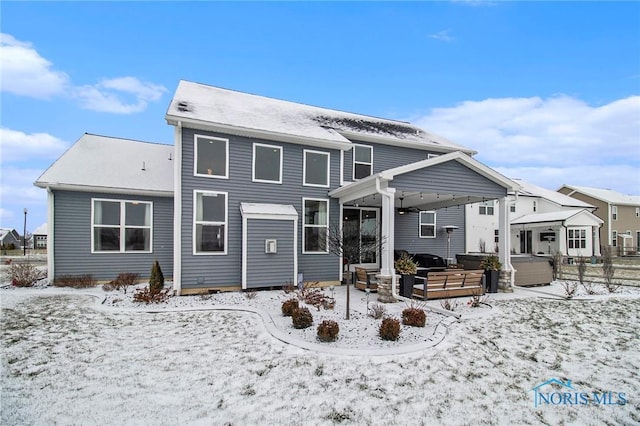 snow covered house with a hot tub