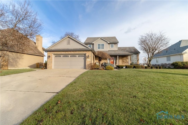 view of front of home with a front yard and a garage