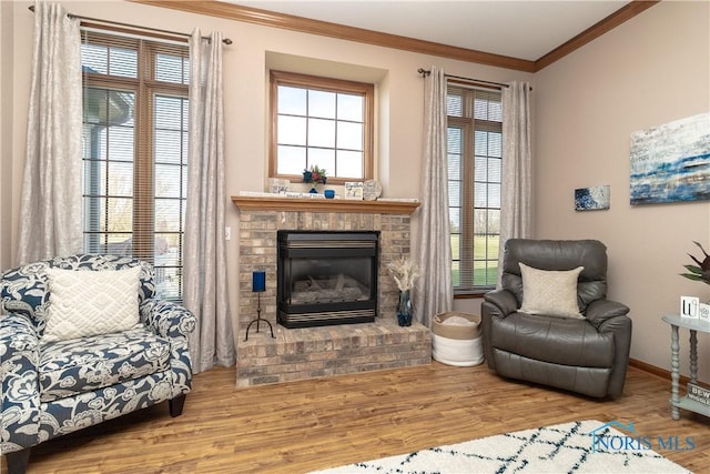 sitting room featuring a fireplace, hardwood / wood-style flooring, a wealth of natural light, and crown molding