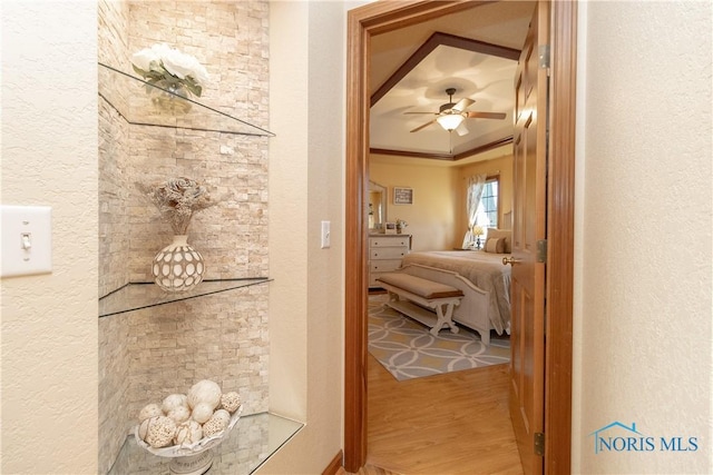 corridor with hardwood / wood-style flooring and ornamental molding