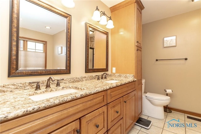 bathroom with tile patterned floors, vanity, and toilet