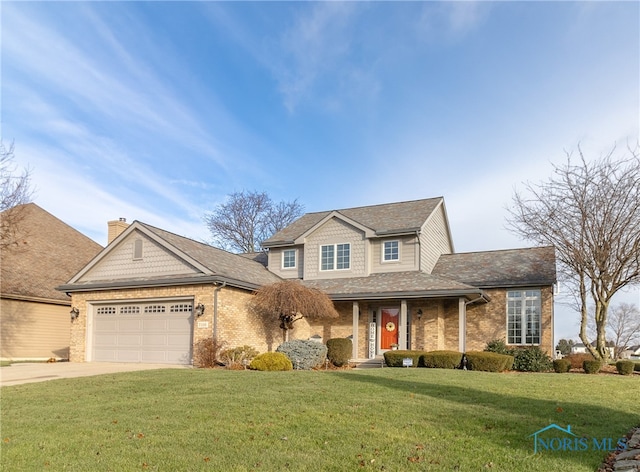 view of front of house with a front yard and a garage