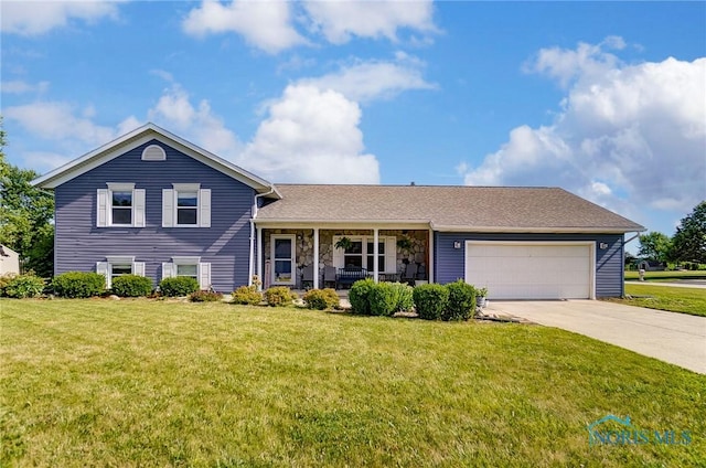 split level home featuring a porch, a garage, and a front lawn