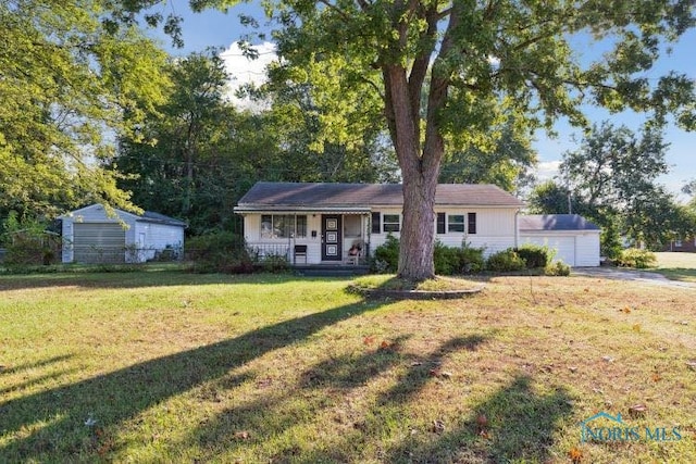 single story home with an outdoor structure, a front lawn, a porch, and a garage