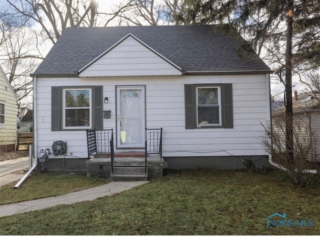 bungalow-style house featuring a front yard