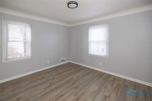 spare room with dark hardwood / wood-style floors