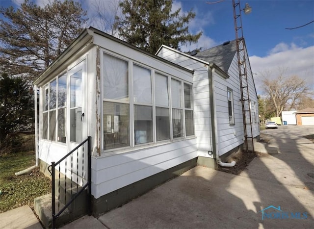 view of side of home with a sunroom