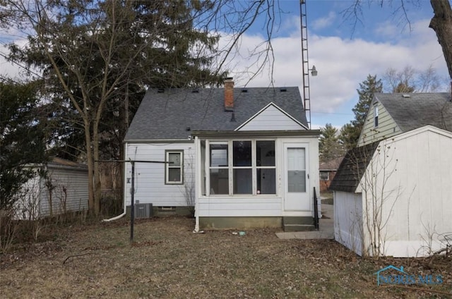 back of property featuring a storage shed