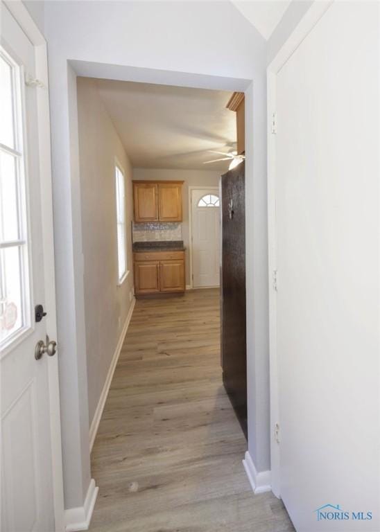 corridor with light hardwood / wood-style floors