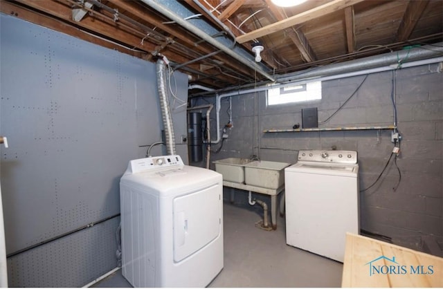 clothes washing area with washing machine and clothes dryer