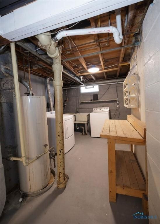 basement with washer and clothes dryer, gas water heater, and sink