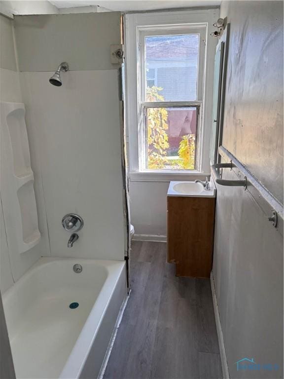 full bathroom featuring toilet, vanity, shower / bathtub combination, and hardwood / wood-style flooring