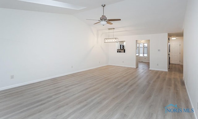 unfurnished living room featuring light hardwood / wood-style floors, vaulted ceiling, and ceiling fan