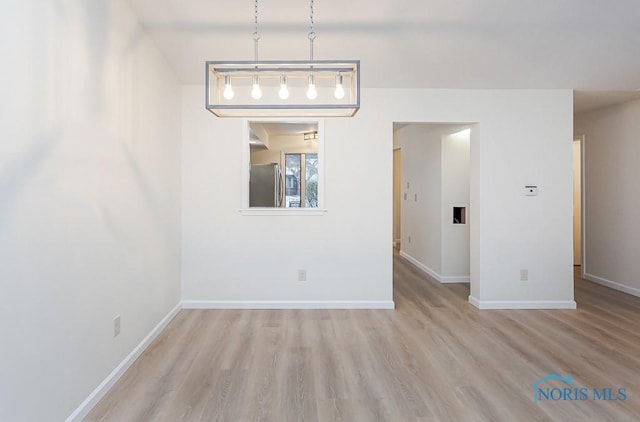 spare room featuring light hardwood / wood-style flooring