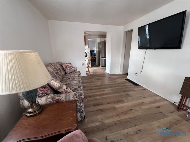 living room with washer / clothes dryer and dark hardwood / wood-style flooring