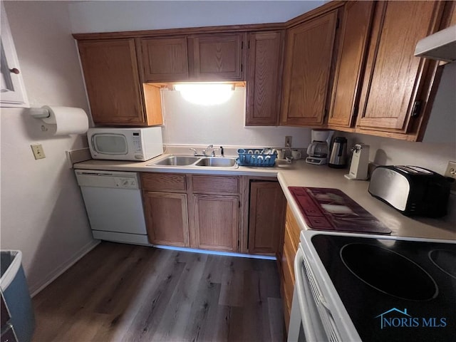 kitchen featuring range hood, sink, white appliances, and light wood-type flooring